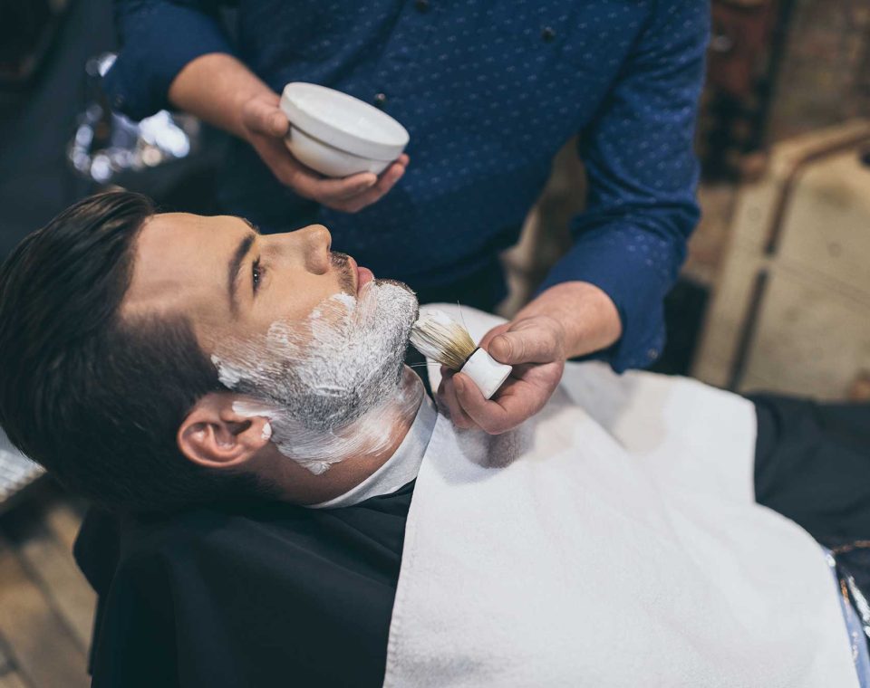 barber-applying-foam-before-shaving-of-customer-in-2022-12-16-17-03-17-utc-2.jpg