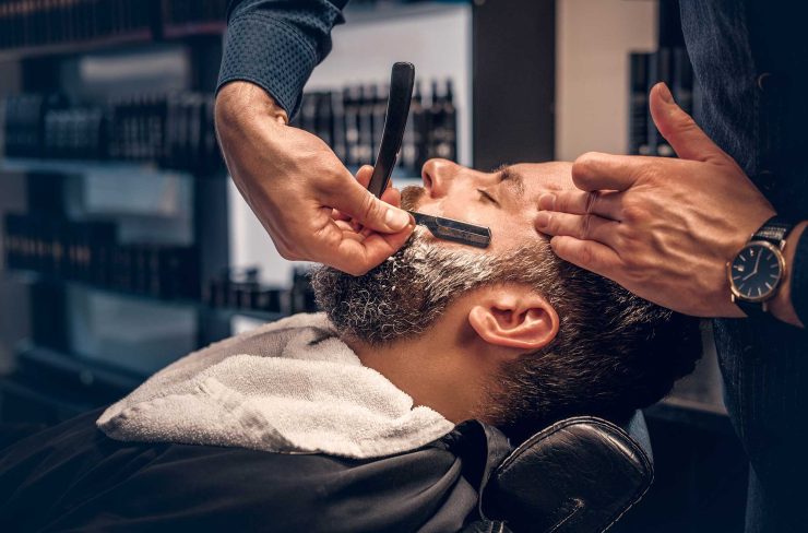 barber-shaving-bearded-male-with-a-sharp-razor-2021-08-28-17-38-11-utc-2.jpg