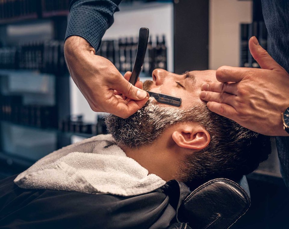 barber-shaving-bearded-male-with-a-sharp-razor-2021-08-28-17-38-11-utc-2.jpg