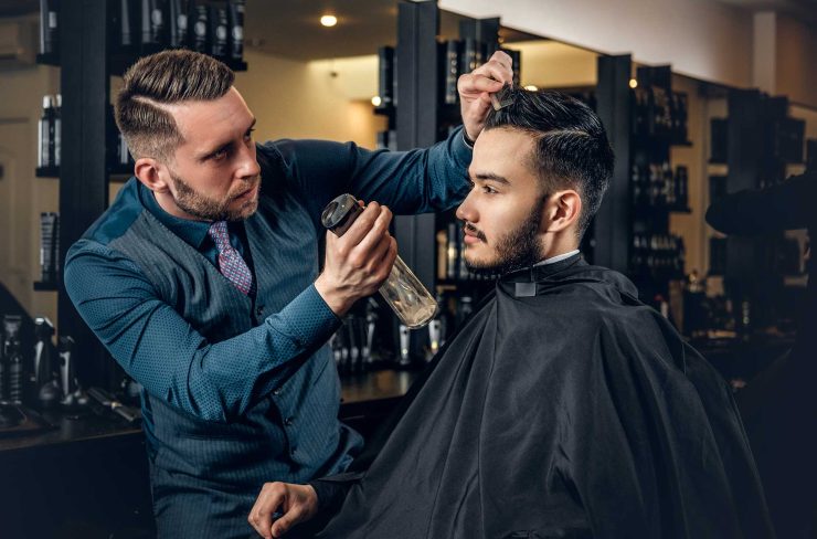 hairdresser-doing-haircut-to-a-bearded-man-in-a-ba-2021-08-28-17-38-11-utc-2.jpg