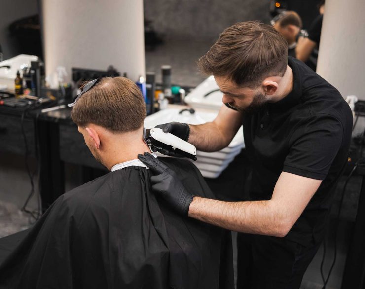 male-hairdresser-making-a-haircut-for-a-young-man-2022-02-17-20-02-40-utc-2.jpg