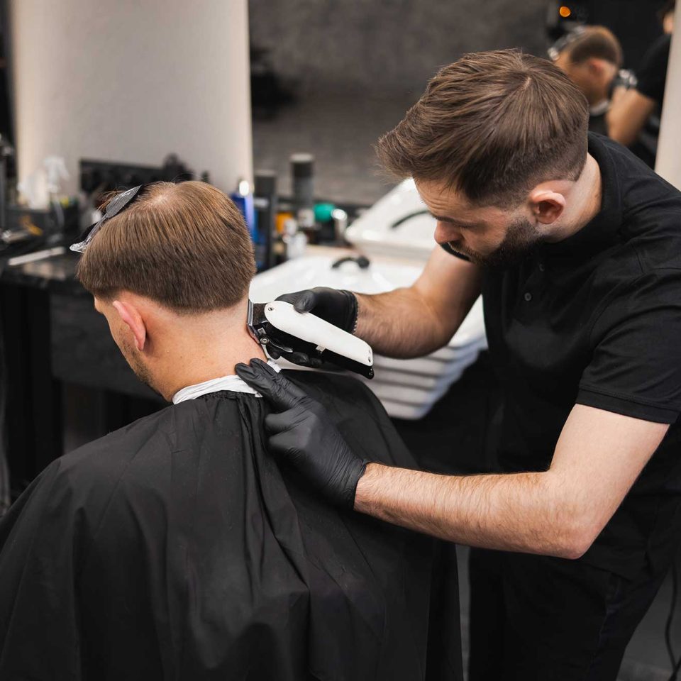 male-hairdresser-making-a-haircut-for-a-young-man-2022-02-17-20-02-40-utc-2.jpg