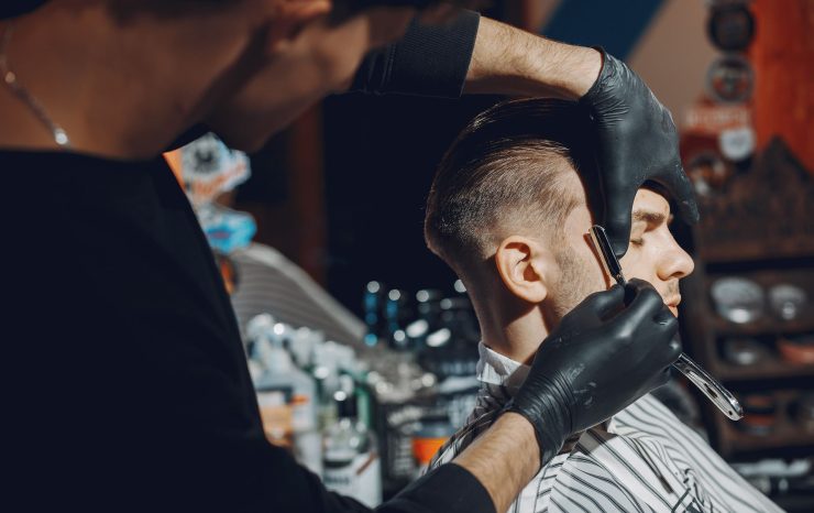 stylish-man-sitting-in-a-barbershop-EYR3SFA-2.jpg