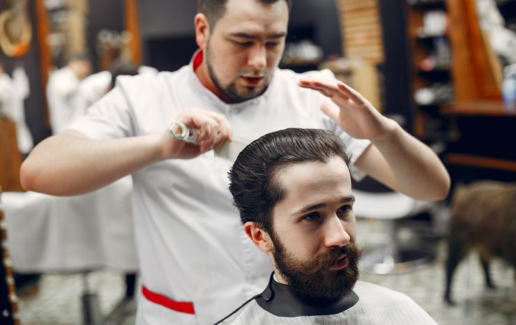 stylish-man-sitting-in-a-barbershop-N3QZCDL-2.jpg